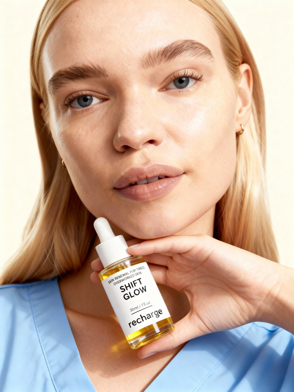 Woman holding a bottle of 'Shift Glow' skincare product with a beige background